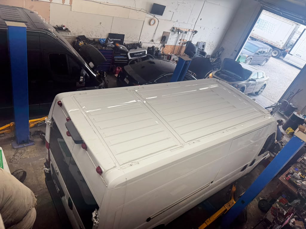 Cargo van positioned in the shop bay awaiting service